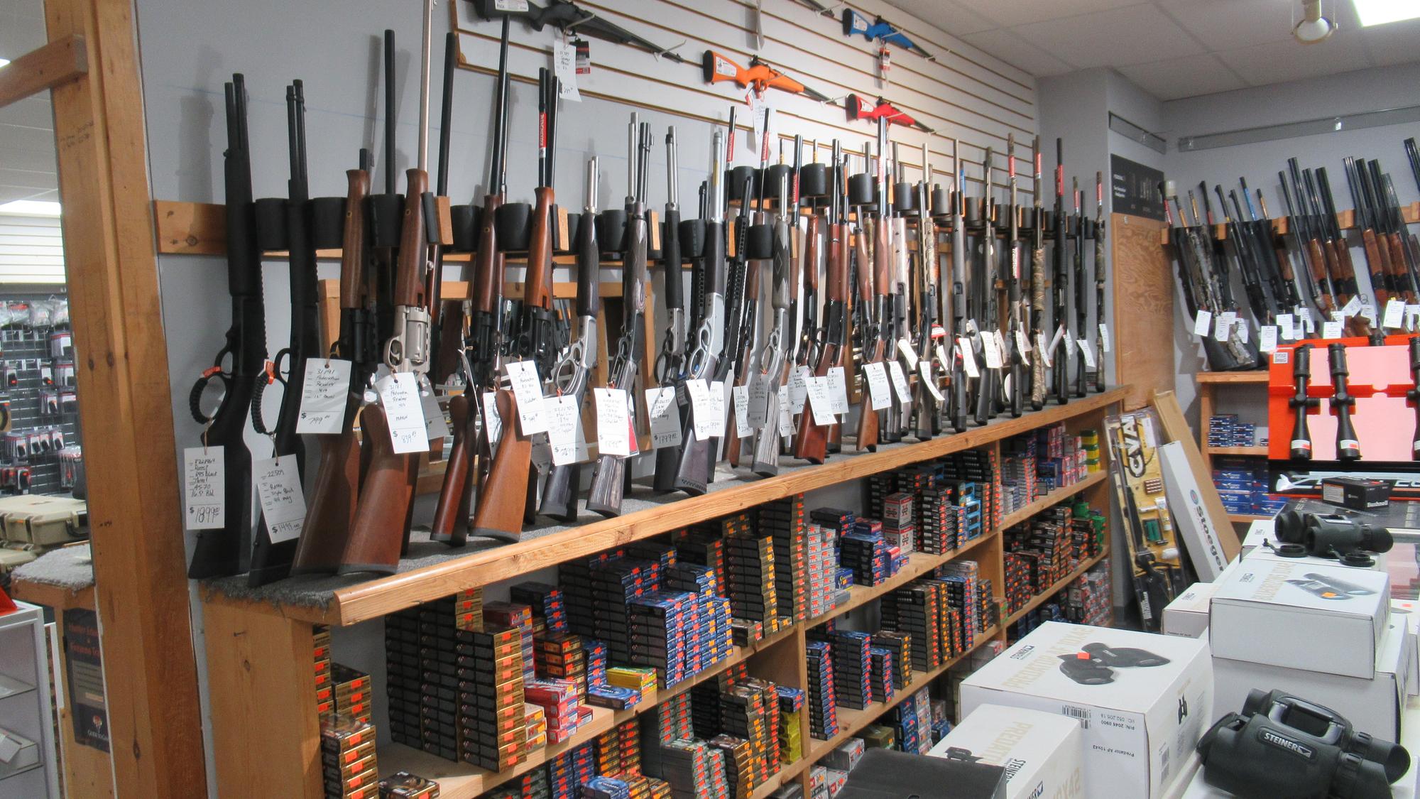 Lever-action rifles, ammunition and binoculars on display